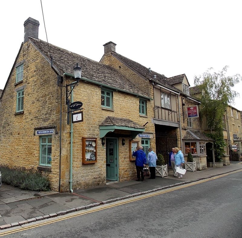 Visitors exploring a Cotswold village square